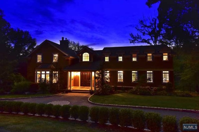 Set a top private 1 acre property on one of Tenafly's most desired streets, surrounded by towering mature trees is this magnificent wood shake home. A graceful 2 story foyer+double door entry foreshadow the elegance+attention to detail evident throughout this home. Soaring cathedral ceilings&richly designed wood accented FL create a dramatic 1st impression the moment you enter. This house has 7 BDR, 5.5 BTH, 2 fireplaces; a huge m.suite with a MBTH+radiant heated floors, rich hardwood floors a sitting area with dual sided fireplace. A huge gourmet kitchen+a large breakfast area overlook the deck, pool+private yard. A total of 5 BDR+3 full baths are on the 2nd floor. A sweeping lawn+stylish hard-scape offer plenty of room for alfresco activities, while the expansive circular driveway+2-car garage provide ample space for parking. Additional amenities include a GRM, butler's pantry, full walk out lower level, a full house generator, water softening system, central audio system+more.