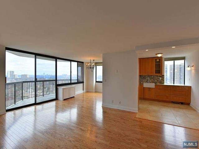 Come home to The GREENHOUSE Tower, Cliffside Park's sought after High Rise residences offering spectacular Hudson River &NYC views from the GWB to midtown. Enter this fully renovated wheel accessible capacious unit, and take in the breath taking views of Manhattan.. With approx. 1200 Sq ft. this unit has it all. The new modern kitchen offers all modern appliances & the breakfast area offers north east views, and the large master suite with the large walk in closet does as well. The2 bedrooms enjoy unobstructed views. The entire hardwood floor has been replaced as were all the doors and the unit freshly painted white. Residents enjoy 24 hour doorman, 2 Parking, porter Service a, gym/ entertainment center/ outdoor pool/sauna. Public transportation right in front of the building with direct shuttles to port authority and the ferry. Conveniently located close to schools, shopping, restaurants and houses of worship.